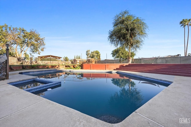 view of pool with an in ground hot tub