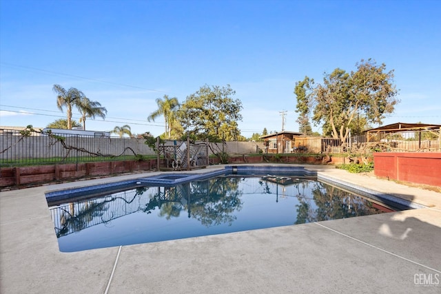 view of pool featuring an in ground hot tub and a patio area