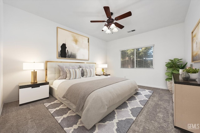 bedroom with visible vents, baseboards, ceiling fan, and dark carpet