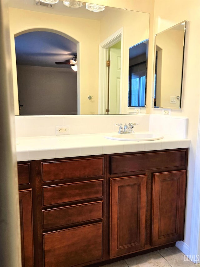 bathroom with ceiling fan, tile patterned flooring, and vanity