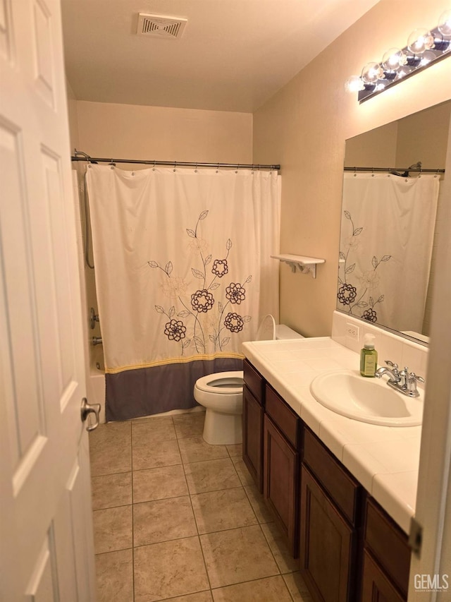 bathroom featuring visible vents, toilet, tile patterned flooring, shower / bathtub combination with curtain, and vanity