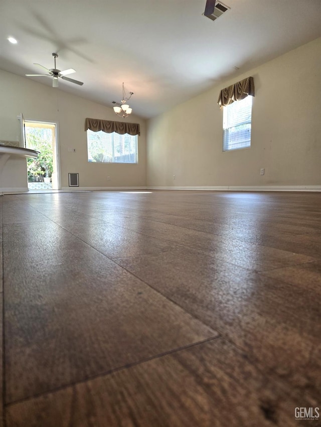 unfurnished room featuring vaulted ceiling, a wealth of natural light, visible vents, and baseboards