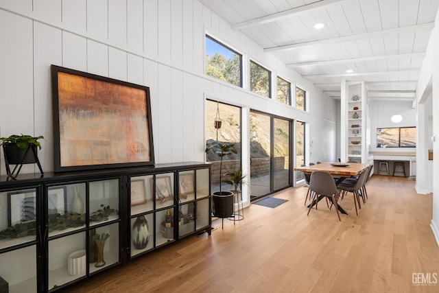 sunroom / solarium featuring beamed ceiling
