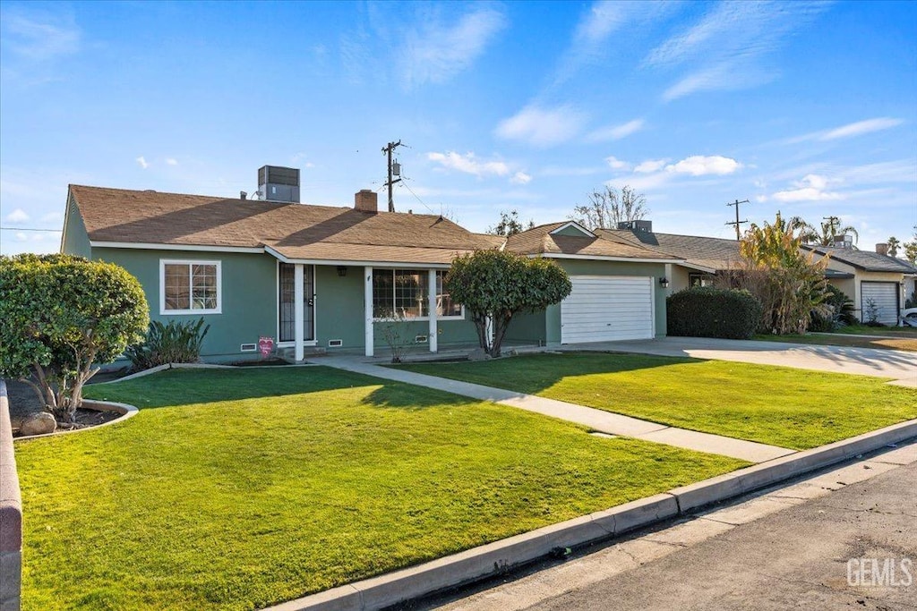 single story home featuring a garage, a front yard, and central AC unit