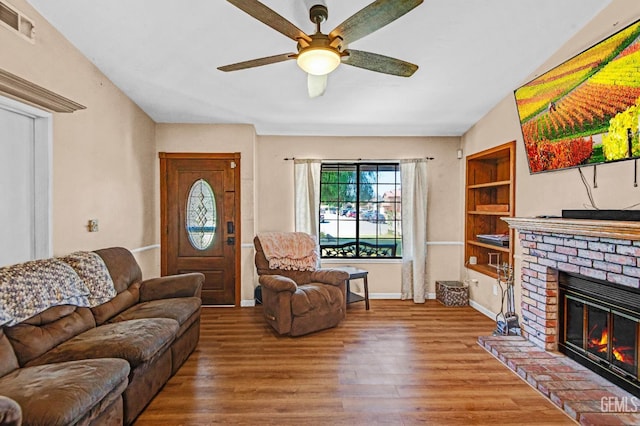 3304 Charlotte St, Bakersfield, CA 93313 - living area with wood finished floors, a ceiling fan, a fireplace, and built in features
