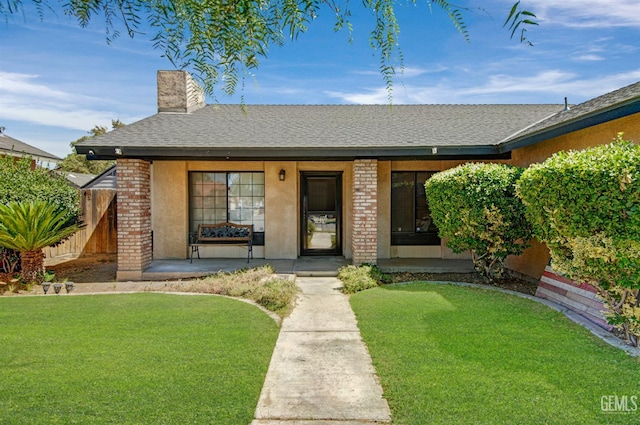 3304 Charlotte St, Bakersfield, CA 93313 - ranch-style home featuring a porch, brick siding, a front yard, and a chimney