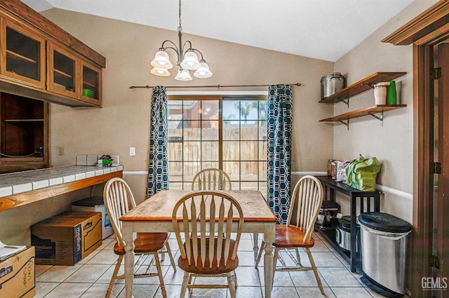 3304 Charlotte St, Bakersfield, CA 93313 - dining space with vaulted ceiling, light tile patterned flooring, and a chandelier