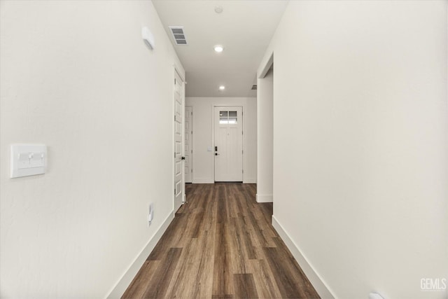 hall featuring recessed lighting, visible vents, baseboards, and dark wood-type flooring