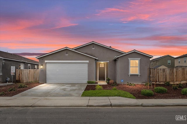 ranch-style house with stucco siding, driveway, an attached garage, and fence