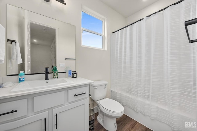 full bath featuring vanity, toilet, wood finished floors, and shower / bath combo