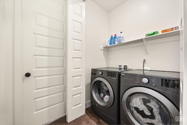 laundry room with washer and clothes dryer, laundry area, and dark wood-style flooring