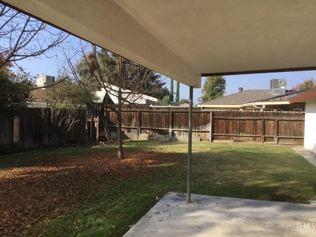 view of yard featuring central air condition unit and a patio area