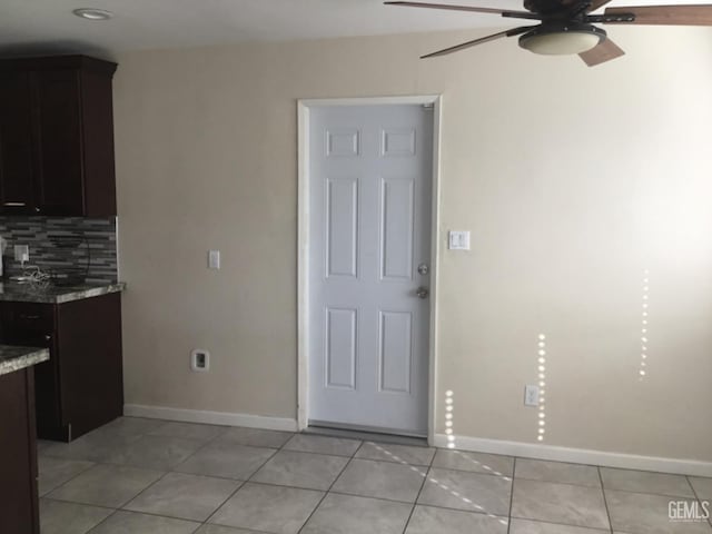 interior space with ceiling fan and light tile patterned floors