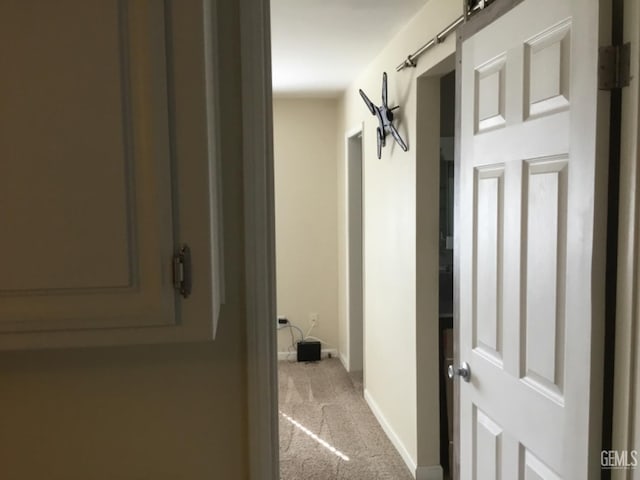 hallway with light colored carpet