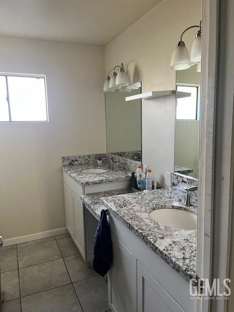 bathroom featuring tile patterned floors, vanity, and a healthy amount of sunlight