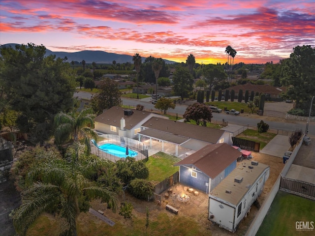 aerial view at dusk featuring a mountain view