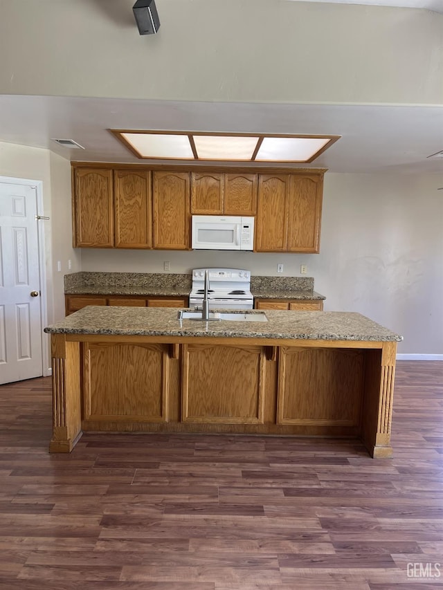 5700 Via Marisol St, Bakersfield, CA 93308 - kitchen featuring white appliances, stone countertops, dark wood finished floors, and brown cabinetry