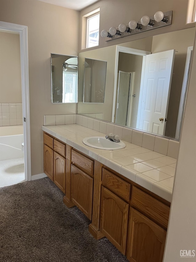 5700 Via Marisol St, Bakersfield, CA 93308 - bathroom featuring vanity, carpet, a shower with door, and a tub