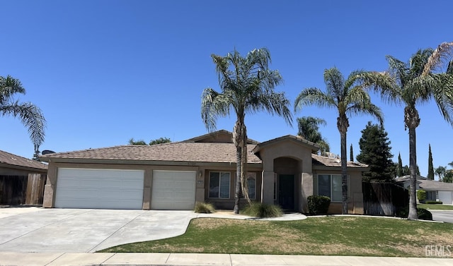 5700 Via Marisol St, Bakersfield, CA 93308 - ranch-style home with driveway, a garage, stucco siding, and a front yard