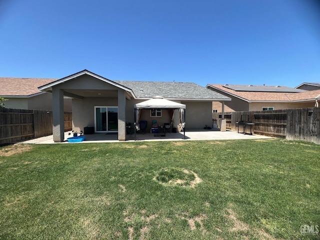 318 Smoke Tree Ct, Wasco, CA 93280 - rear view of property with a patio, stucco siding, and a shingled roof