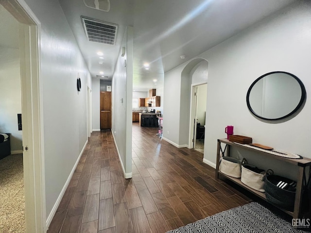 318 Smoke Tree Ct, Wasco, CA 93280 - hallway with dark wood-type flooring, arched walkways, baseboards, and recessed lighting