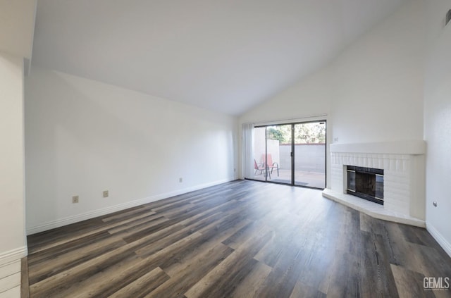 unfurnished living room with high vaulted ceiling, a fireplace, and dark wood-type flooring