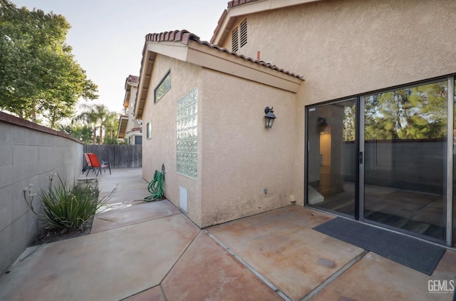 rear view of property featuring a patio area