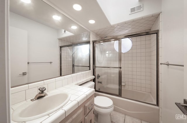 full bathroom featuring tile patterned floors, vanity, backsplash, bath / shower combo with glass door, and toilet