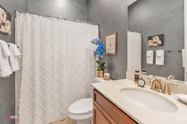 9803 Petersburg Pl, Bakersfield, CA 93306 - full bath with vanity, toilet, tile patterned floors, and curtained shower