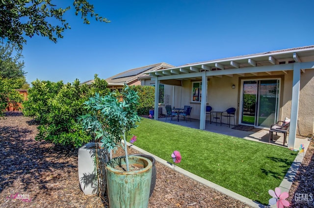 9803 Petersburg Pl, Bakersfield, CA 93306 - back of property featuring stucco siding, a patio area, and a lawn