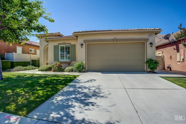 9803 Petersburg Pl, Bakersfield, CA 93306 - mediterranean / spanish house with driveway, an attached garage, stucco siding, and a tiled roof