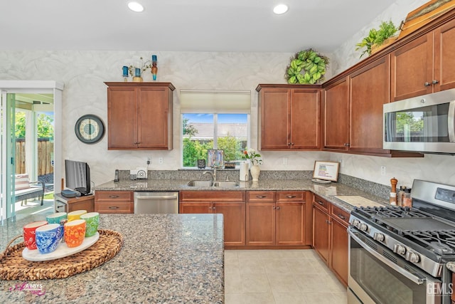 9803 Petersburg Pl, Bakersfield, CA 93306 - kitchen featuring appliances with stainless steel finishes, plenty of natural light, a sink, stone countertops, and recessed lighting