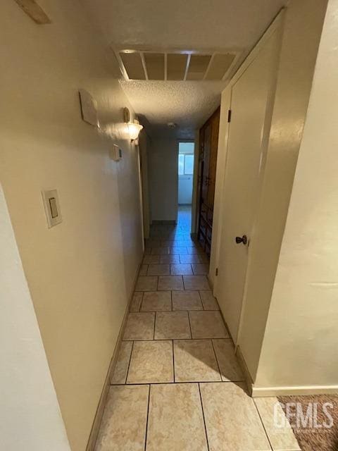 3609 Planz Rd, Bakersfield, CA 93309 - corridor with baseboards, a textured ceiling, visible vents, and light tile patterned floors