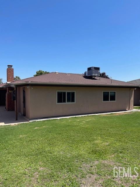 3609 Planz Rd, Bakersfield, CA 93309 - back of property featuring a patio, a chimney, central air condition unit, and a yard