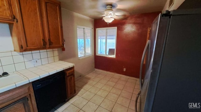113 Easy St, Bakersfield, CA 93308 - kitchen featuring freestanding refrigerator, black dishwasher, ceiling fan, and tile counters