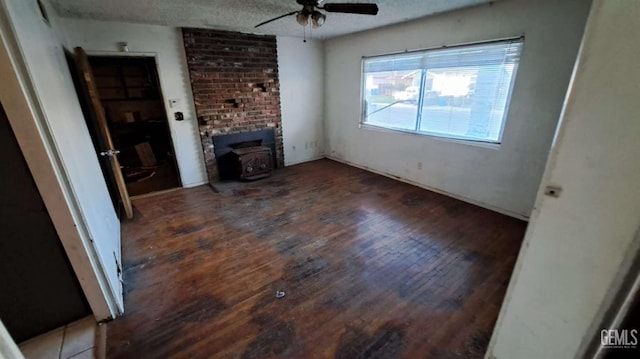 113 Easy St, Bakersfield, CA 93308 - unfurnished living room with hardwood / wood-style flooring, ceiling fan, a wood stove, and a textured ceiling