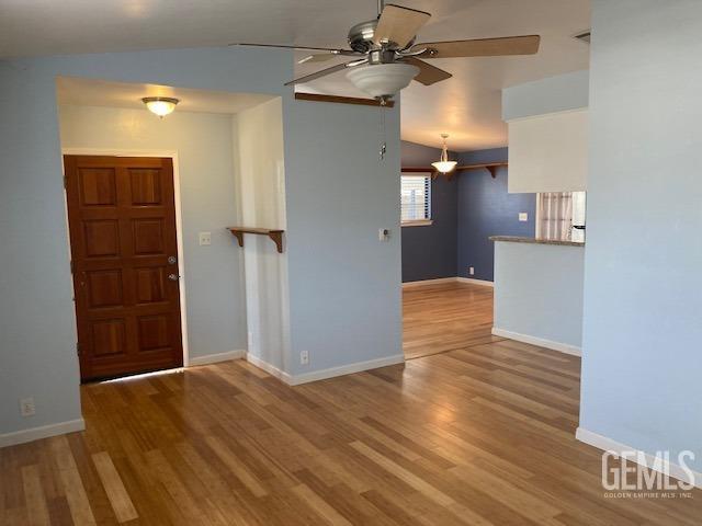 entrance foyer featuring ceiling fan, light hardwood / wood-style flooring, and lofted ceiling