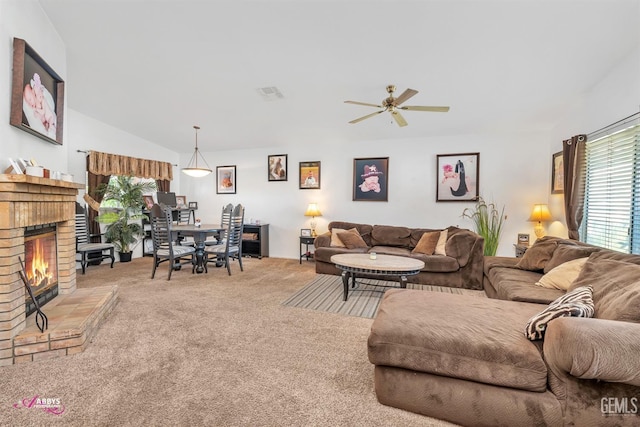 living room with visible vents, a brick fireplace, ceiling fan, carpet, and vaulted ceiling