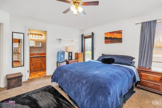 bedroom with a sink, carpet, ensuite bath, and ceiling fan