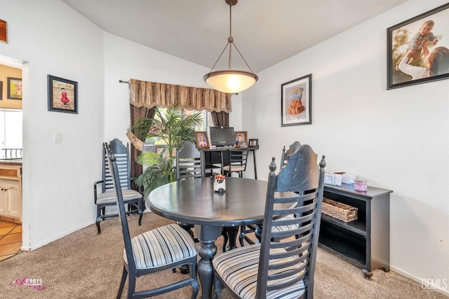 dining room featuring a wealth of natural light, baseboards, and light colored carpet