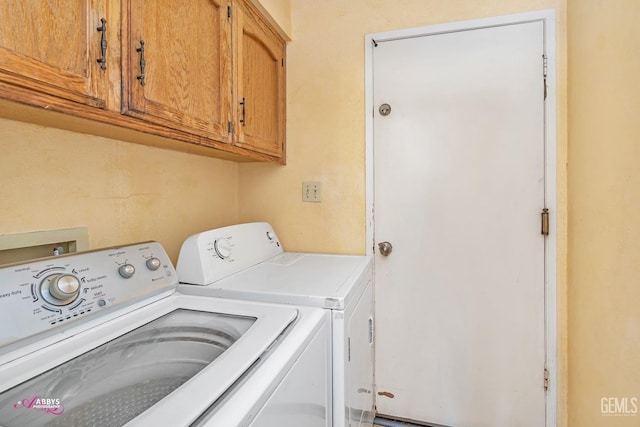 laundry room with cabinet space and washing machine and clothes dryer