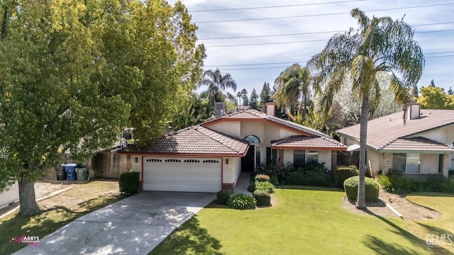 view of front of home featuring concrete driveway, a tile roof, a front yard, stucco siding, and a garage