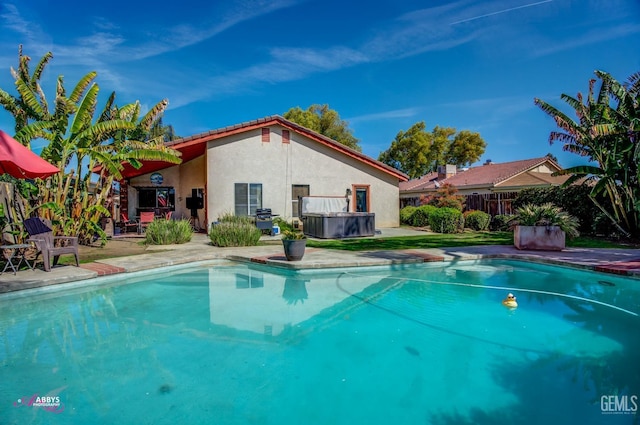 outdoor pool with a jacuzzi, a patio, a grill, and fence