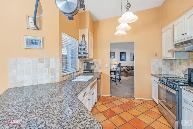 kitchen featuring under cabinet range hood, light tile patterned floors, appliances with stainless steel finishes, white cabinets, and a sink