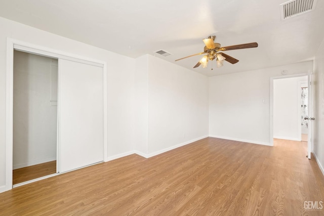 unfurnished room with ceiling fan and light wood-type flooring