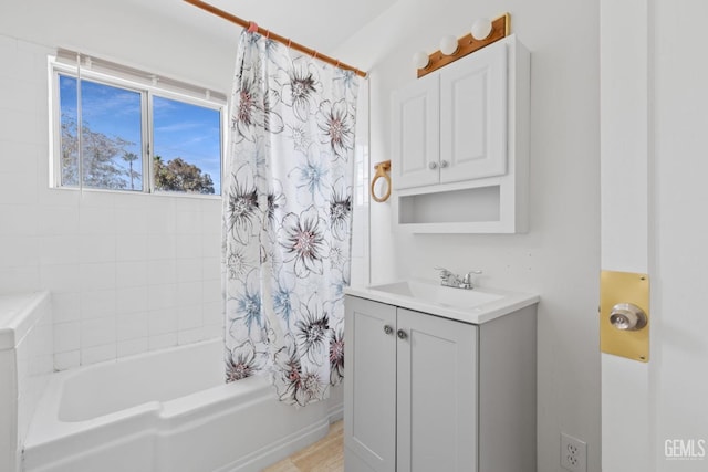 bathroom featuring shower / bath combo and vanity