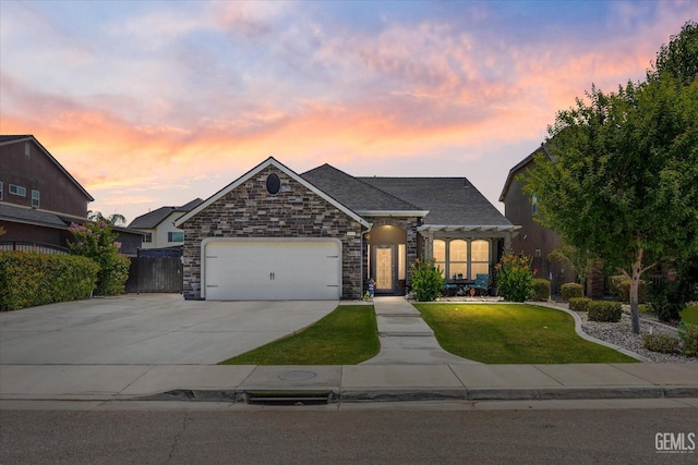 6315 Cape Cod Ave, Bakersfield, CA 93313 - view of front of house featuring an attached garage, concrete driveway, and stone siding