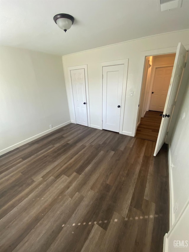 unfurnished bedroom featuring dark wood-type flooring