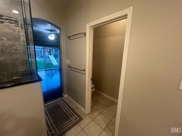 bathroom featuring tile patterned flooring, toilet, and baseboards