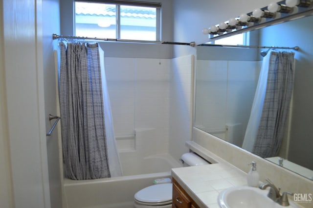 bathroom featuring plenty of natural light, vanity, toilet, and shower / bath combo with shower curtain